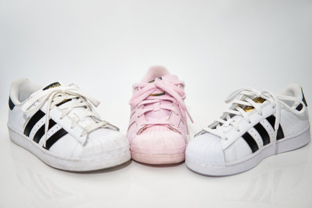bangkok,Thailand,July 2,2021-original adidas  sneakers shoes with shoelace half white and pink on white floor front view soft focus with copy spaceのeditorial素材