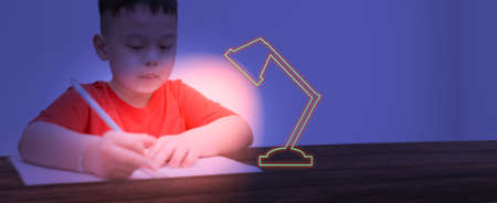 asian boy kid concentrate to write and draw homework before back to school in learning indoor education lessonの写真素材