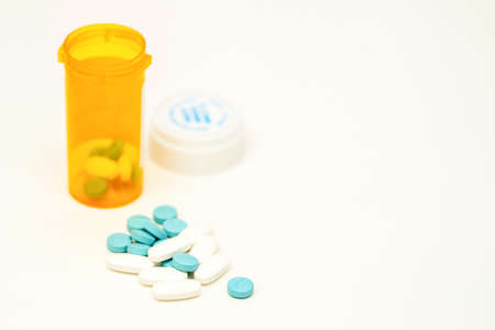 pills drug medicine tablets pour out bottle for supplement vitamin healthcare illness treatment concept in pharmacist open and label then spill them for prescribeの写真素材