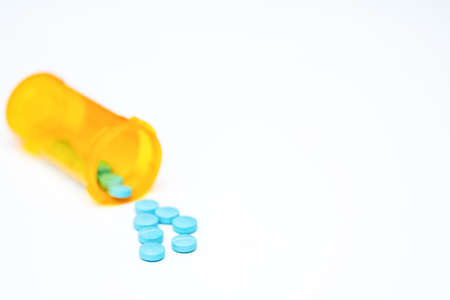 pills drug medicine tablets pour out bottle for supplement vitamin healthcare illness treatment concept in pharmacist open and label then spill them for prescribeの写真素材