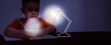 asian boy kid concentrate to write and draw homework before back to school in learning indoor education lessonの写真素材