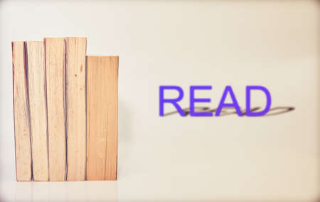 stack of books arranged horizontally on white background blur read wordの写真素材