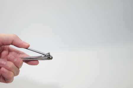 hand hold Nail clipper or cutter isolated on whiteの写真素材