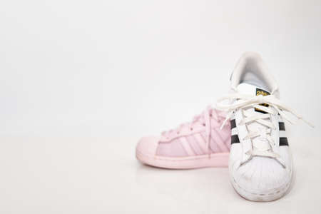bangkok,Thailand,July 2,2021-original adidas  sneakers shoes with shoelace half white and pink on white floor side view soft focus with copy spaceのeditorial素材
