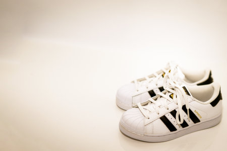 bangkok,Thailand,July 2,2021-original adidas  sneakers shoes with shoelace on white floor side view soft focus with copy space vintage styleのeditorial素材