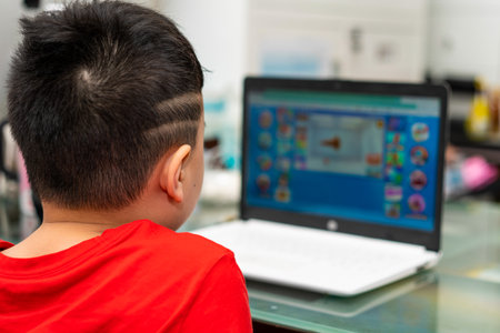 kid do education by online learning with laptop or tablet computer at home in quarantine called e-learning communication to teacher or tutorの写真素材