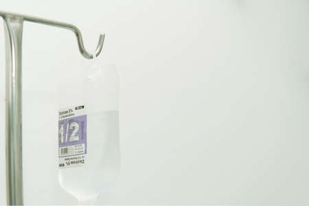 Saline bottle hang on pole for doctor use to treat patient with fluid replacement therapyの写真素材