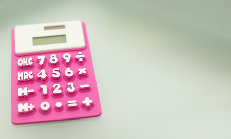 purple calculator made of rubber use math calculations with copy spaceの写真素材