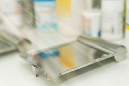 pill counting tray on pharmacy lab counter with sun lightacの写真素材