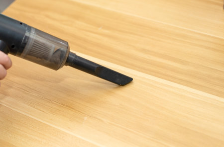 portable vacuum cleaner for housework use by hand on tableの写真素材