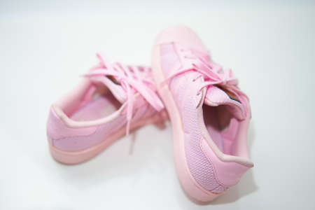 pink sneakers shoes with shoelace top angle view on floor soft focusのeditorial素材