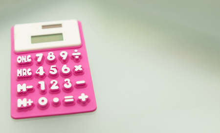 purple calculator made of rubber use math calculations with copy spaceの写真素材