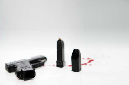 bottom of pistol magazine hand gun and blur ammo magazine loader selective focus isolated on white high angle view and copy spaceの写真素材
