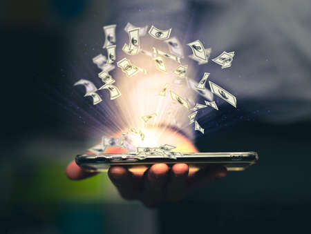 a businessman holding a cell phone with a lot of bills gushed out Represents investment ideas to make money from investments via mobile phone.の写真素材