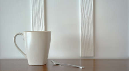 coffee cup and spoon on table bar in the morning