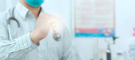 doctor exam eye with flashlight in medical healthcare check upの写真素材