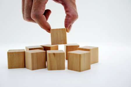 hand pick wood cube amoung cubes for man recruit job search conceptの写真素材