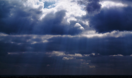 Sun rays which peek through the cloudsの写真素材