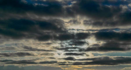dark clouds curtain the Sun and skyの写真素材