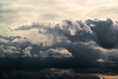 Blue Sky with storm clouds lit up by the Sunの写真素材
