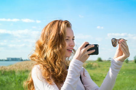 model photographing themselves with smartphoneの写真素材