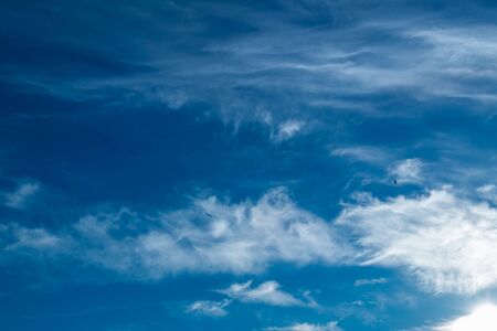 white Cirrus clouds on a blue sky above rural sceneryの写真素材