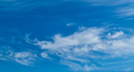 white Cirrus clouds on a blue sky above rural sceneryの写真素材