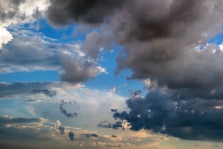 Cumulus clouds in the blue sky at sunset