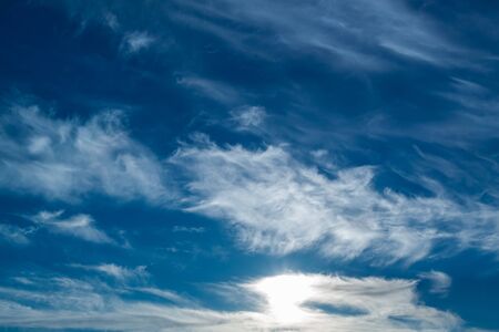 white Cirrus clouds on a blue sky above rural sceneryの写真素材