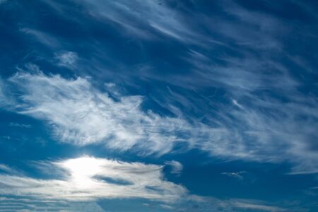 white Cirrus clouds on a blue sky above rural sceneryの写真素材