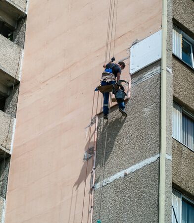Climber installer on high-rise buildingの写真素材