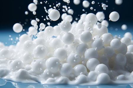 Milk splashes on a blue background. Close-up.の素材