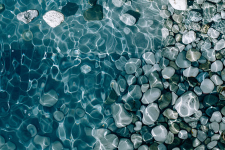 The surface of the water in the pool with pebbles.の素材
