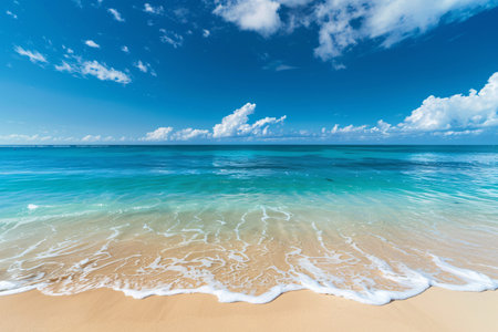 Clear blue ocean meeting a sunny sky, gentle waves caressing a sandy beach.の素材