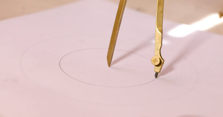 Drawing compass on a white sheet of paper. Close-up.の写真素材