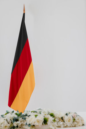 German flag and flowers on a white background with space for text.の写真素材