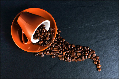 Cup with coffee beans.