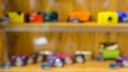 Blurry cameras and lenses in camera store shelf. Great image for your backgroundの写真素材