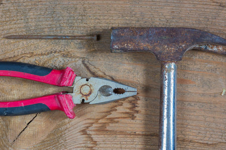 Different tools on a wooden background. Nails, hammer, pliersの写真素材