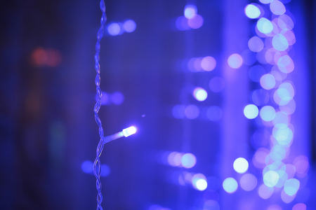 abstract blurred of blue and silver glittering shine bulbs lights background:blur of Christmas wallpaper decorations concept.xmas holiday festival backdrop:sparkle circle lit celebrations display.の写真素材