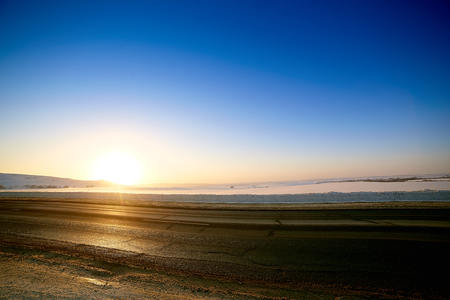 Winter road through snowy fields and forestsの写真素材