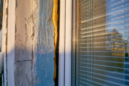new plastic window in old abandoned brick wall fixed with special foam. simple house renovation.の写真素材