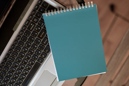 Business, Finance, Analysis concept. A workplace with a laptop keyboard, a blank notebookの写真素材