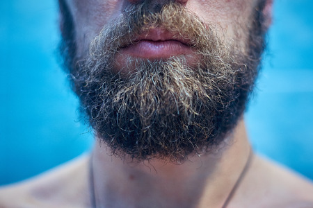 Mens short beard and lips close up.