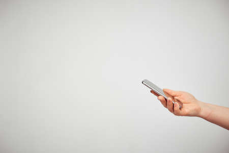 communication, communication, communication. female hand holding smartphone on white background
