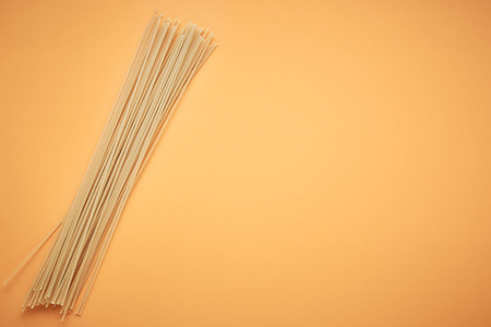 Italian spaghetti on orange backgroundの写真素材