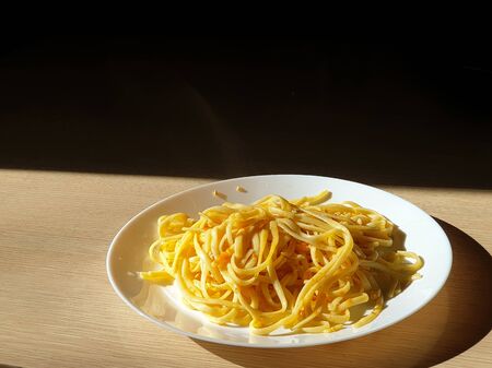 concept of cooking homemade food, spaghetti on a white plate, cooking at home during quarantine