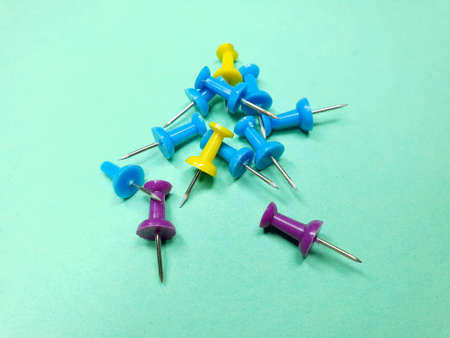 colorful stationery buttons on a green backgroundの写真素材