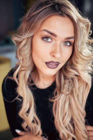 Close up view of beautiful woman lips with purple matt lipstick. Open mouth with white teeth. Cosmetology, drugstore or fashion makeup concept. Beauty studio shot. Passionate kissの写真素材