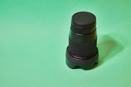 camera lens with protective cover on a green backgroundの写真素材